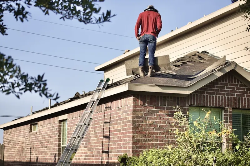 Professional roofer working on a residential roof in East Troy